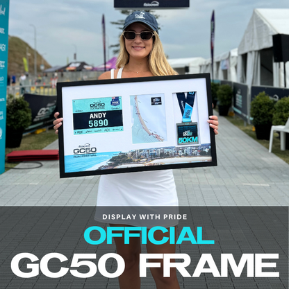 Woman holding a framed map at a finish line with 'FINISH' sign and timer.